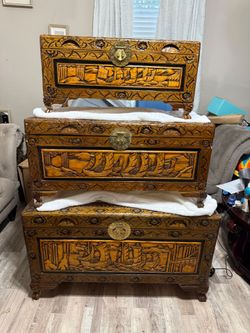 3 hand carved wooden nesting trunks, with entricate carvings and brass hardware