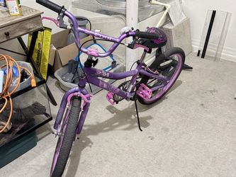Girl purple bike with helmet