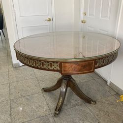 Gorgoeus antique 47 inch round table with brass accents  