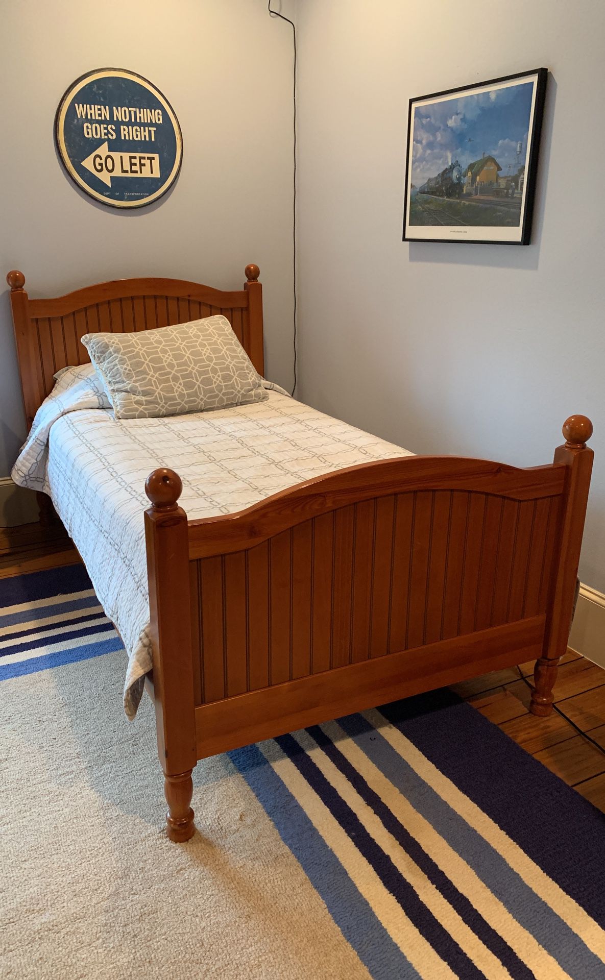 Two Pottery Barn twin beds with mattresses and linens