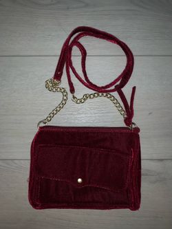 a burgundy velvet crossbody handbag
