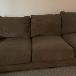 Brown couch and loveseat