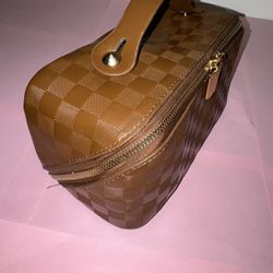 Brown and tan checkered makeup bag 