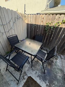 Folding chairs and glass table - patio. If post is still up it’s still available