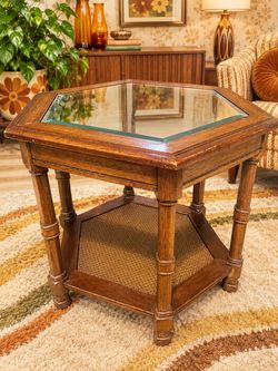 This is a vintage 1970's mid-century hexagonal wood end table featuring a beveled glass top