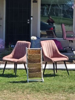 2 pink chairs and fruit stand