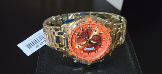 AJ Luxury  Orange dial and gold tone watch.