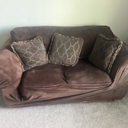 brown loveseat and single seat couches