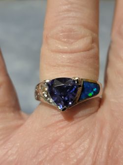 Beautiful Solid 925 Silver That Is Also Rodium Plated With A Natural Blue Sapphire And White AAA White Cz's On One Side And Fire Blue Opal Size 7. 