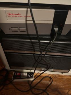 NES with 2 controllers, gun, and cabinet