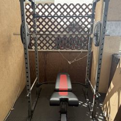 Gym Rack, Bowflex Bench, Barbell, 15lb and 10lb Olympic Weights, Plus Magnetic Clamps