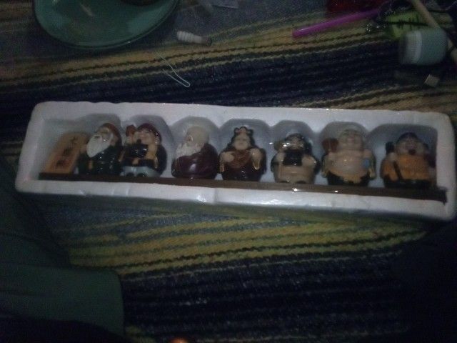 A Set Of Seven Buddha Type Figurines 