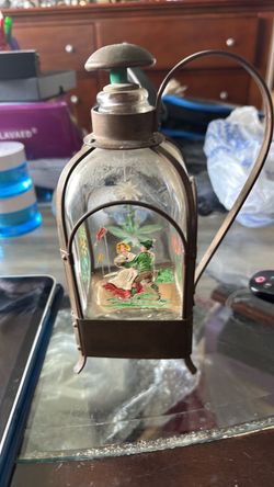 This is a charming vintage musical liquor decanter and bar caddy (frequently referred to as a musical bottle or bar display piece), typically dating f