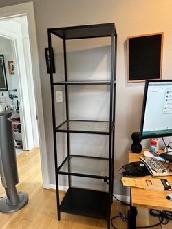 Black metal and glass IKEA bookshelf
