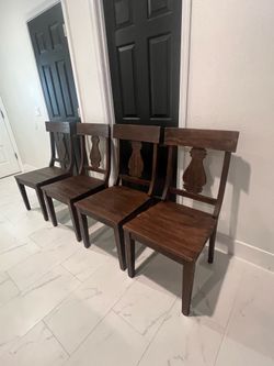 4 World Market dining chairs - solid wood well made