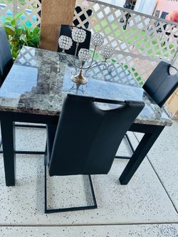 Dining table with 4 leather chairs.