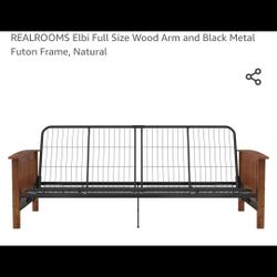 New In Box Beautiful REALROOMS Elbi Full Size Wood Arm and Black Metal Futon Frame in a natural wood finish.