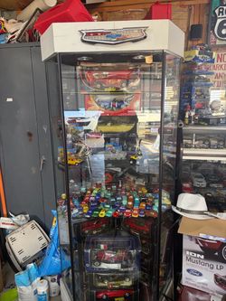 Tall glass display case $125.00 or best offer cars are not included