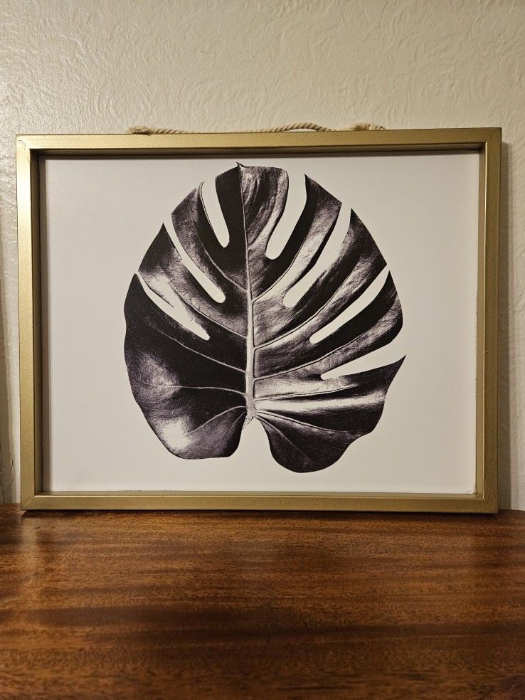 Gold Framed Black And White Print Of A Monstera Plant Leaf