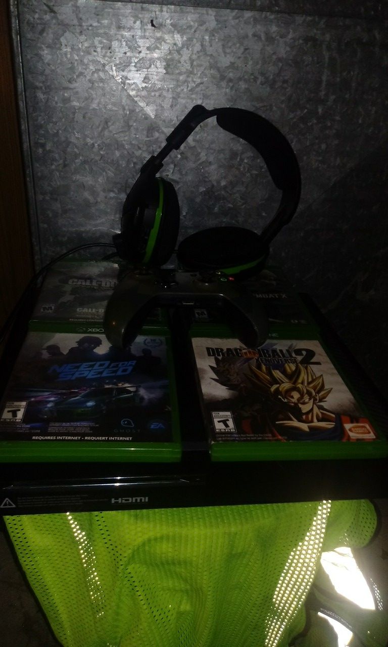 Xbox one with 1 remote 1 headset and 4 games