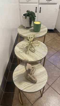 Three modern sophisticated round tables with metal gold legs