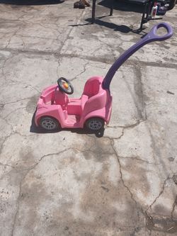 Little kids push car