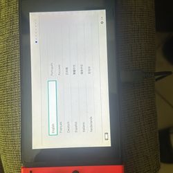 Nintendo switch bundle, original black controller and thrown in the red controller