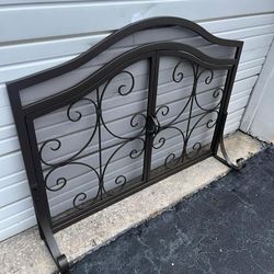 Gray metal fireplace screen with doors that open 44 x 34. Comes with 5 piece fire accessories set