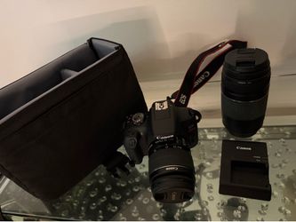 EOS REBEL T7 CAMERA. WITH ONE EXTRA LENS, CASE AND CHARGING PORT FOR BATTERY.