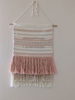 Pink blanket and wall tapestry