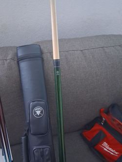 Two pool cues one brand is cuesoul the other brand is McDermott lucky cues the bag is adhafer pool cues bag and the red and black tools are two cue he
