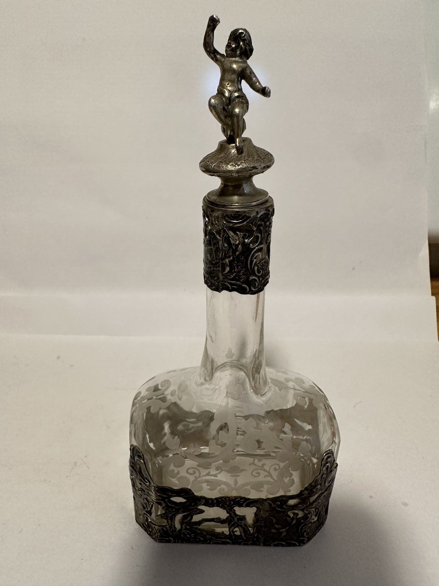 German Silver-mounted Glass Decanters, Hanau, late 19th/early 20th century, Storck & Sinsheimer, maker, each colorless glass bottle