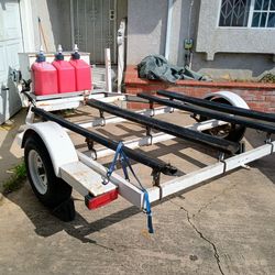 Large 2 jet ski trailer 8 feet by 14 feet, with gear box, gas can holder and spare tire. Have pink slip,current registration.