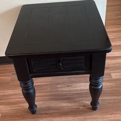 Black wooden end table with drawer