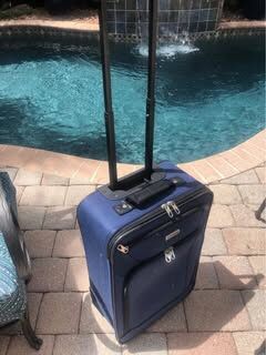 Blue American Tourister Carry On Suitcase. 22” H x 14 1/2” W x 7” D