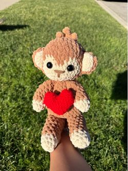Crochet monkey holding a heart