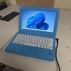 Blue-themed Windows 11 Laptop with charger
