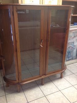 Antique curio with curved glass front,three shelves and lock and key