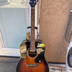 The Epiphone PR-150 VS is a budget-friendly dreadnought acoustic guitar, featuring a spruce top, mahogany back/sides, and a distinctive vintage sunbur