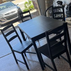 Black Ikea table with 4 chairs