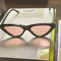 cat-eye sunglasses with a black frame and pink lense