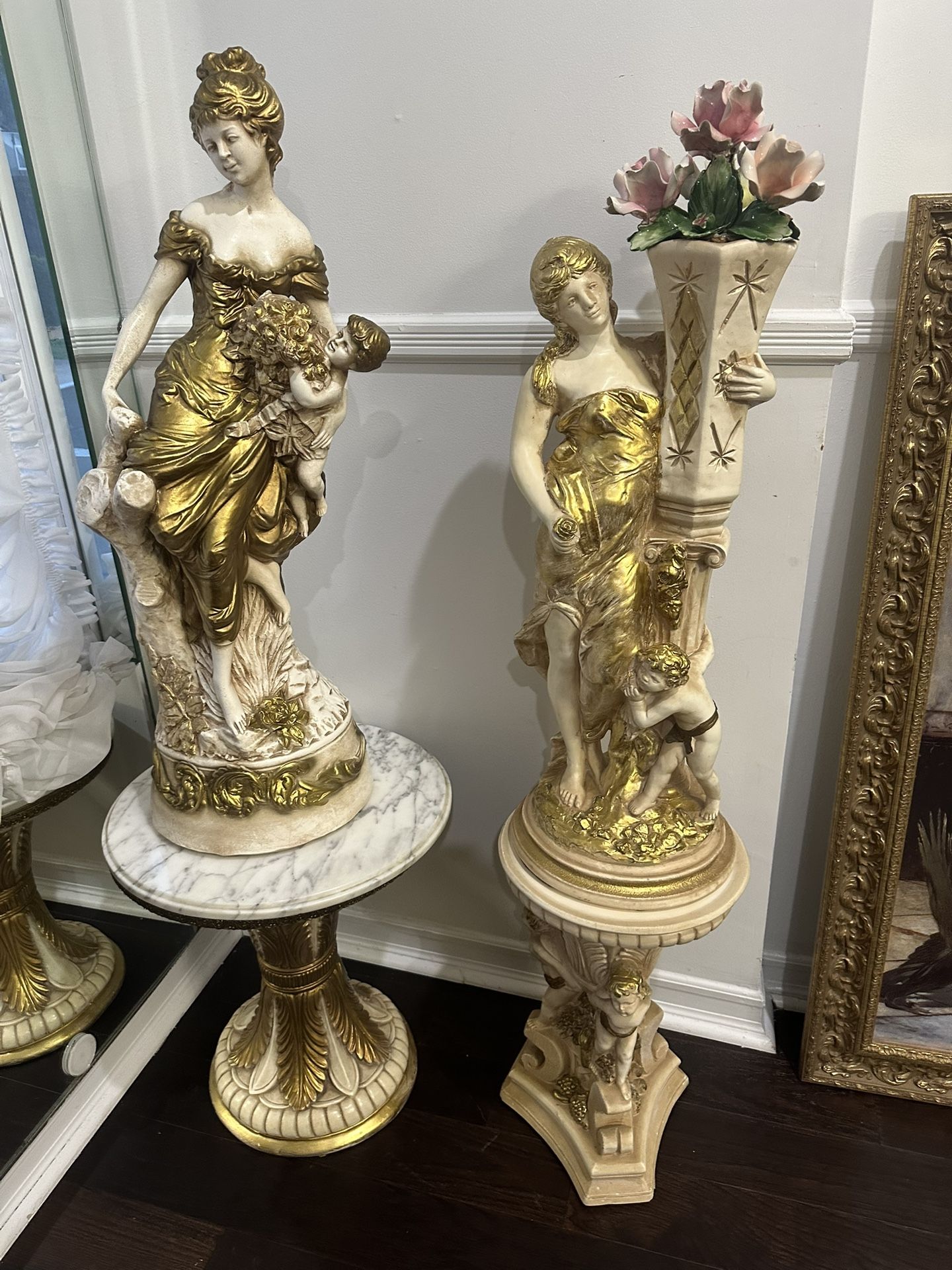Two Set Of Statues With Two Stands