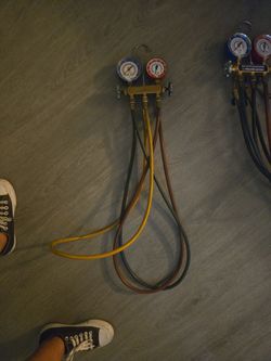 Yellow Jacket Series 41, 2-valve analog manifold, with 3⅛-inch gauges and three hoses.