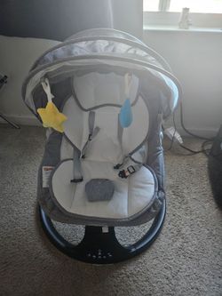 Baby rocker with attached toys