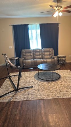 Full living room set. Leather couch, coffee table, hammock, rug, two side table tables