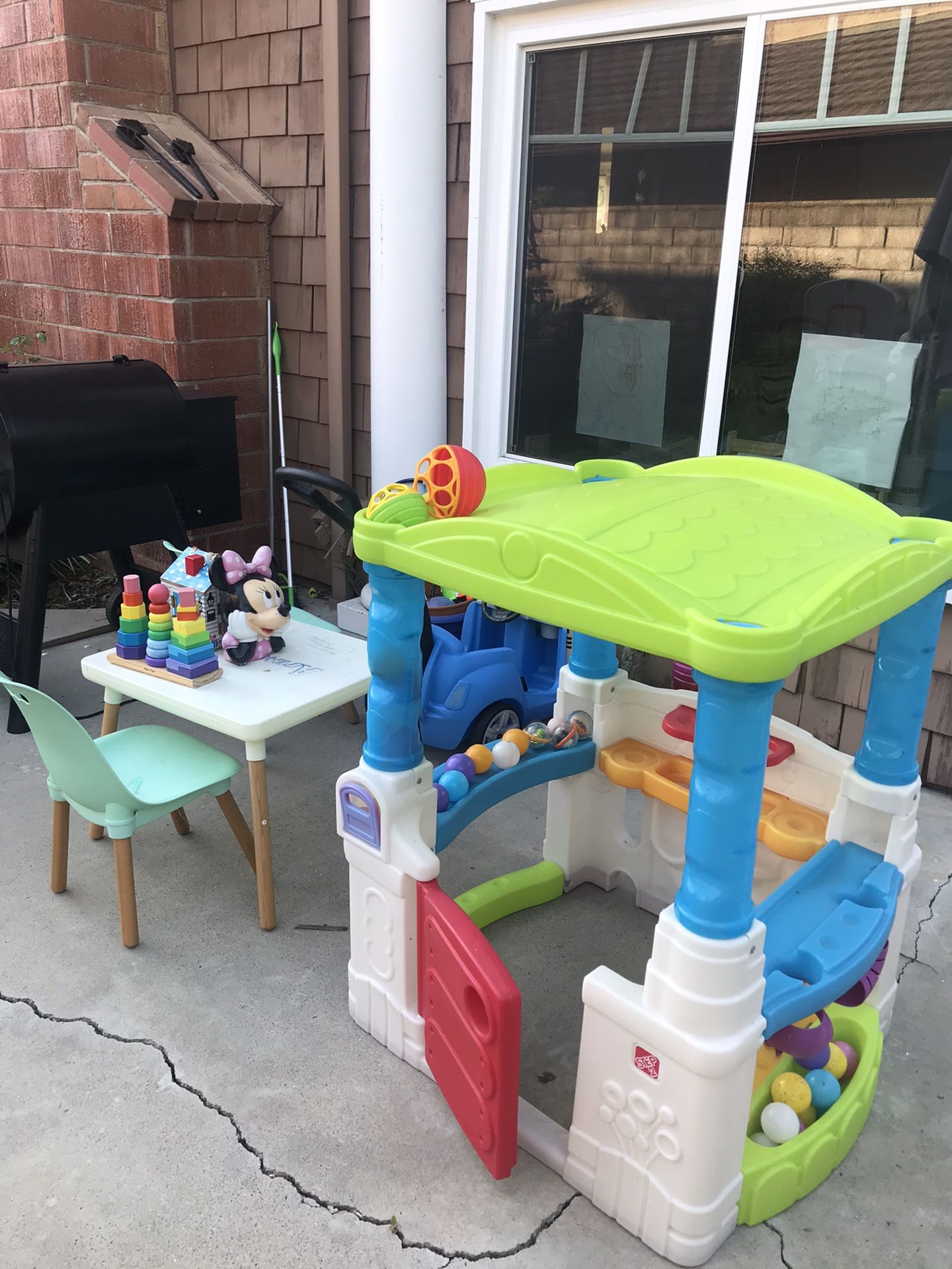 Kids toy house, table with chairs, and push car.