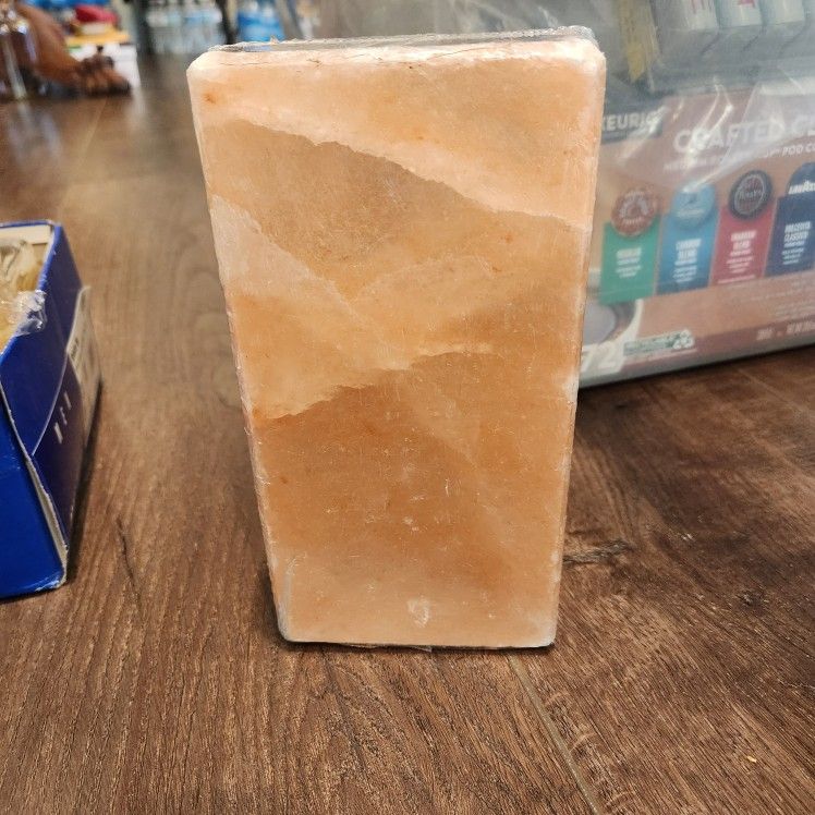 New sealed Himalayan salt block, commonly used for cooking, grilling, or as a decorative item.