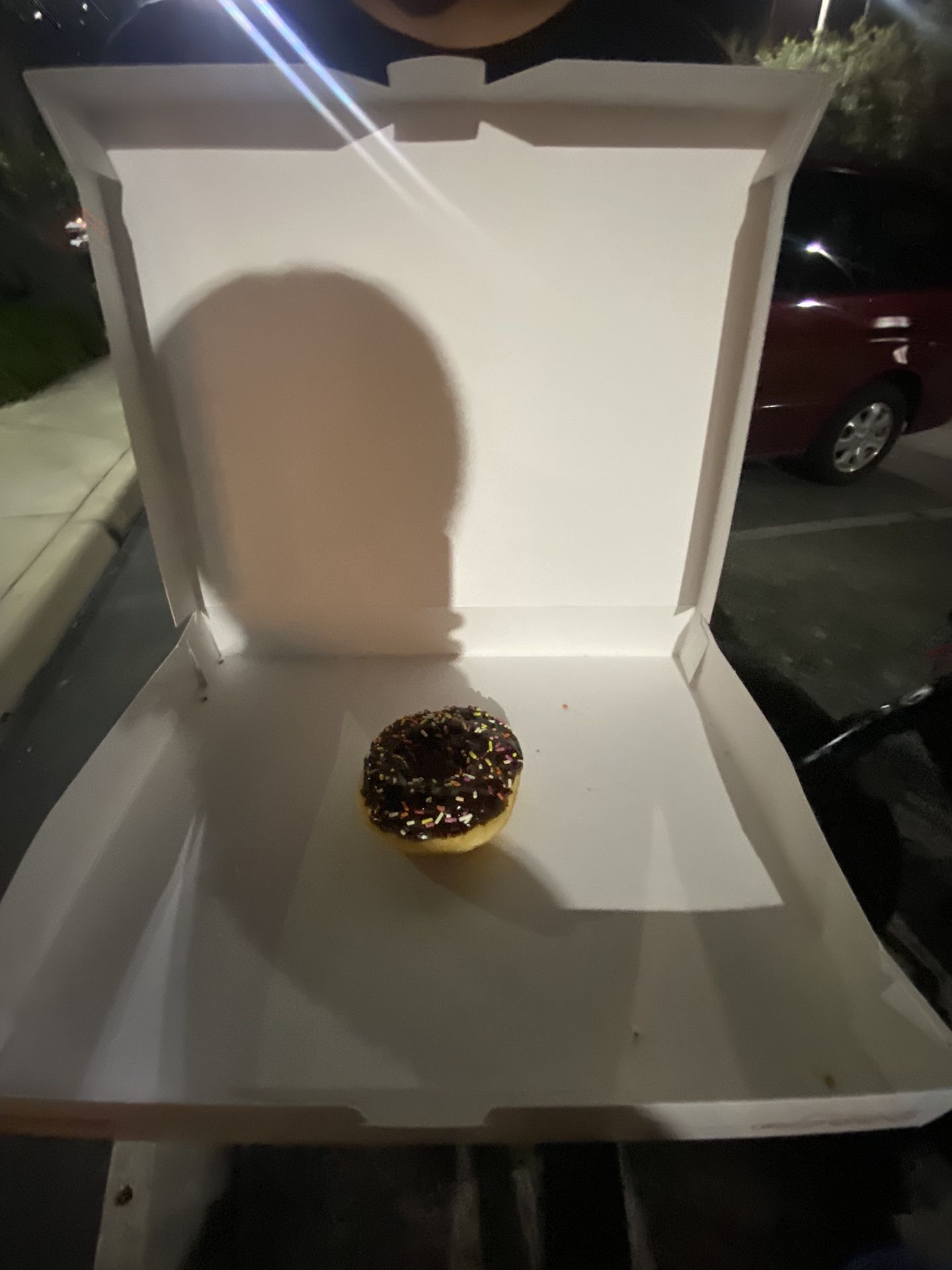 Black chocolate donut with sprinkles 