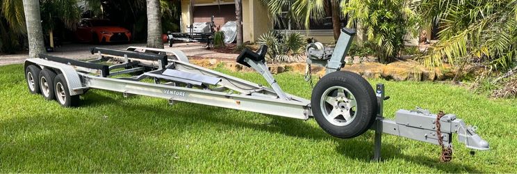 Aluminum VENTURE triple Axel trailer up to 30’ boat of 18,000lb. Registration. Good 15 tires on 6 lug alloy rims. Electric brakes. All components are 