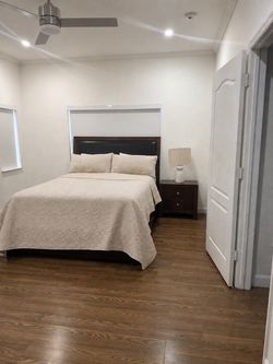 Queen-size bed with box spring, mattress, and nightstand